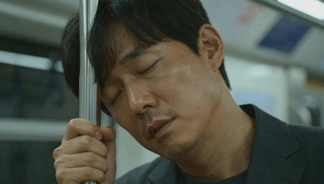 Middle-aged man sleeping standing in subway