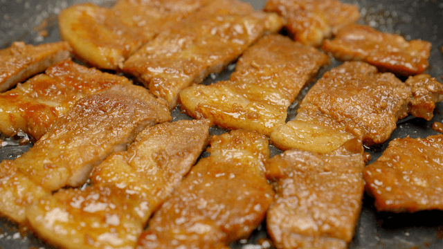 Grilled marinated pork slices sizzling