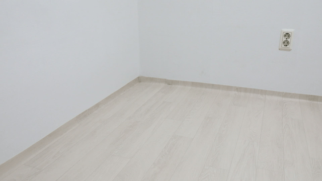 Empty corner of a room with a power outlet