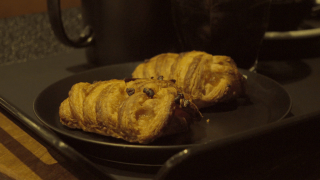Pastries on a black plate indoors