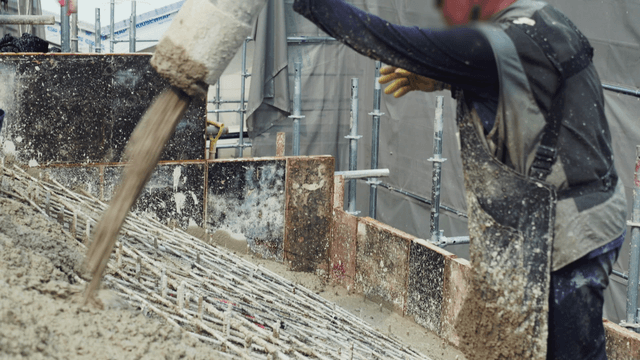 Worker pouring concrete on a construction site