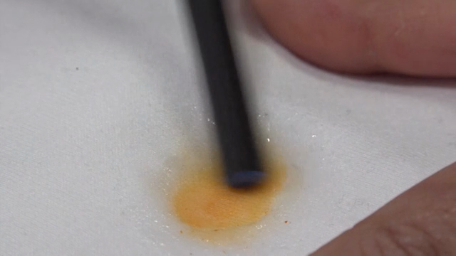 Cleaning a stain on white fabric