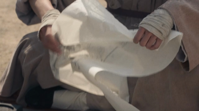 A person tearing an ink painting