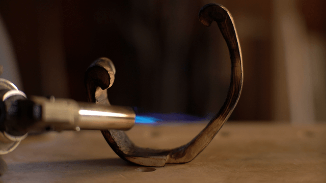 Artisan processing wood with a blowtorch