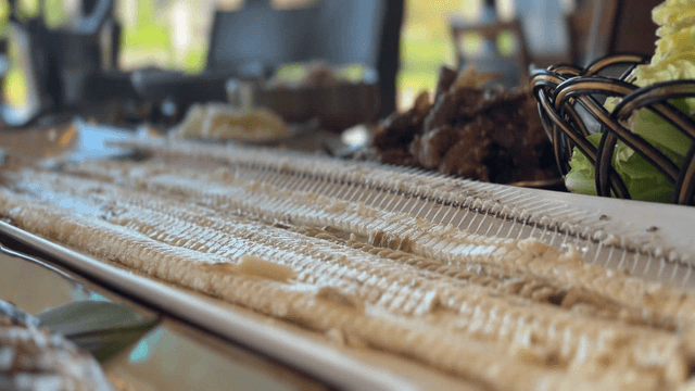 Neatly arranged fillets of grilled cutlassfish on a table