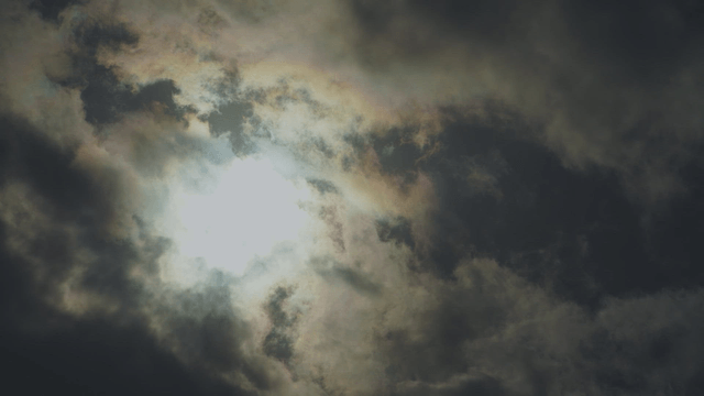 Sunlight breaking through dark clouds