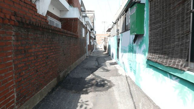 Narrow alleyway between brick buildings