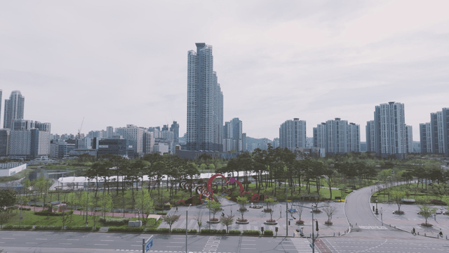 Modern cityscape with tall buildings and park