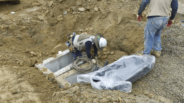 Workers installing cables at a construction site