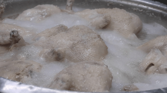 Whole chickens boiling in a pot