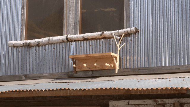 Wooden shelf placed beneath a metal wall window