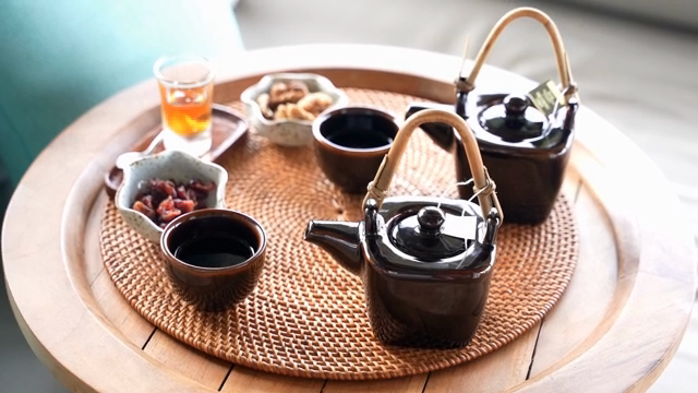 Tea set with snacks on a woven tray