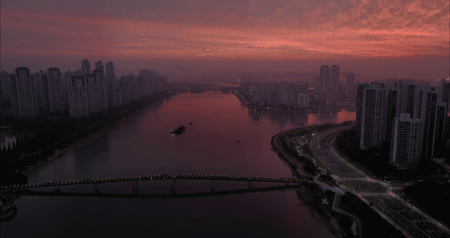 City skyline at dusk with a river