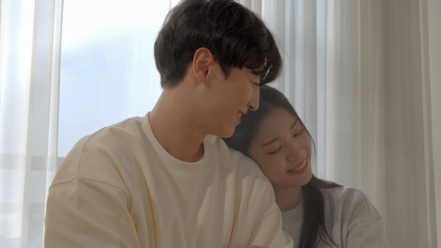 Couple resting together by sunlit window