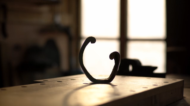 Semi-circular wooden sculpture in a cozy workshop