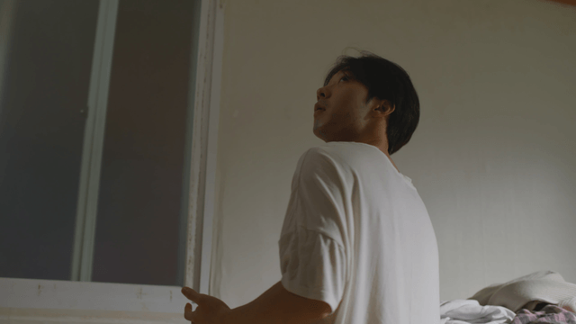 Man looking up in a dimly lit room