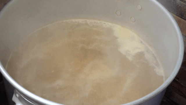 Broth boiling in a large pot in the kitchen