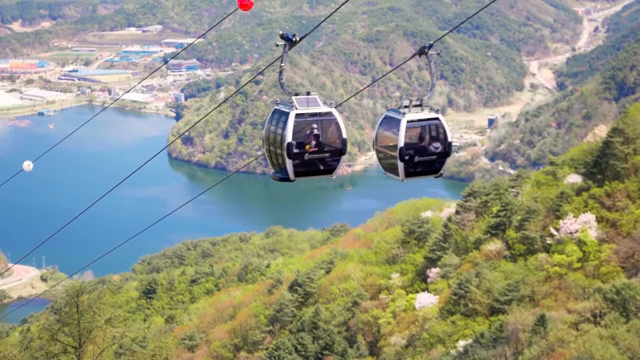 Cable cars over a scenic mountain landscape