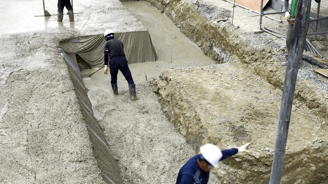 Construction workers pouring concrete