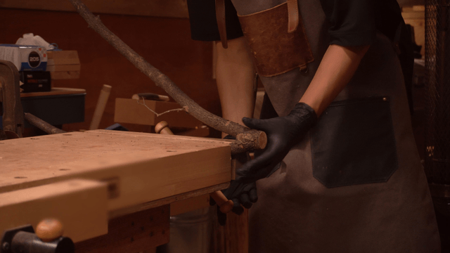 Woodcraft artisan securing wood in workshop