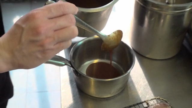 Chef preparing sauce in a kitchen
