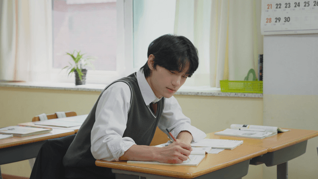Student attentively taking notes in class