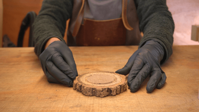 Woodcraft artisan making a wooden candlestick in workshop