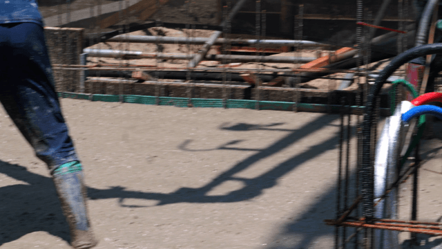 Workers pouring concrete at a construction site