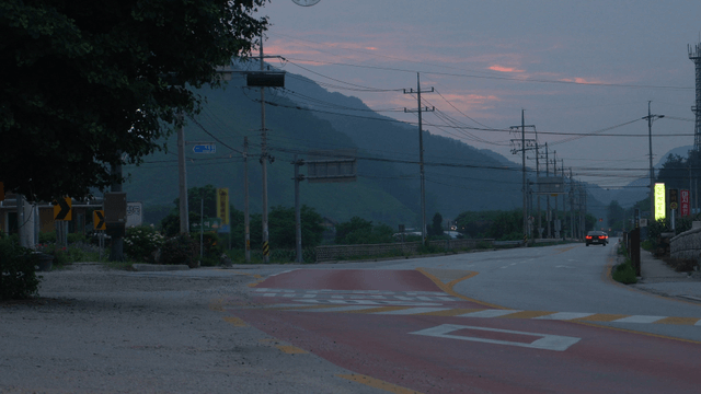 Quiet rural road at twilight with mountain view