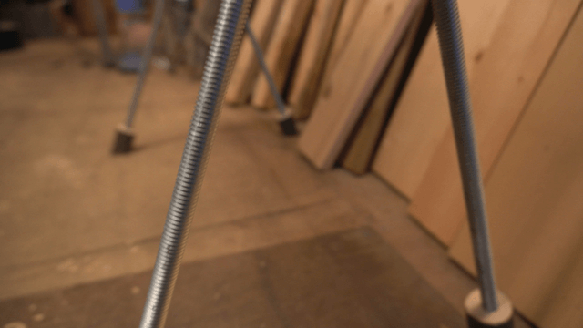 Handcrafted wooden bench with metal legs in workshop