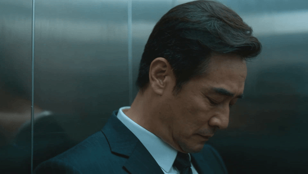 Businessman leaning against elevator wall