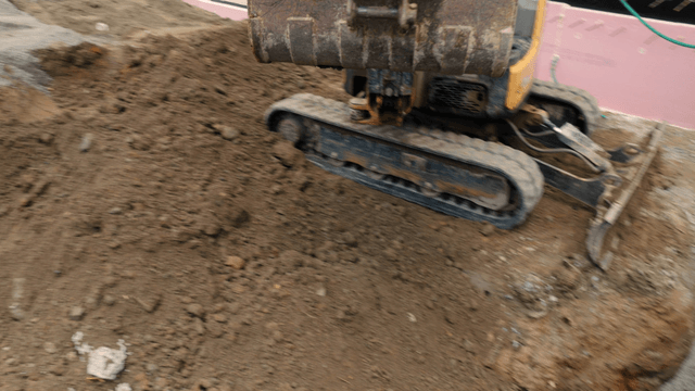 Excavator moving soil at a construction site