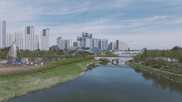 Peaceful lake park with modern city background