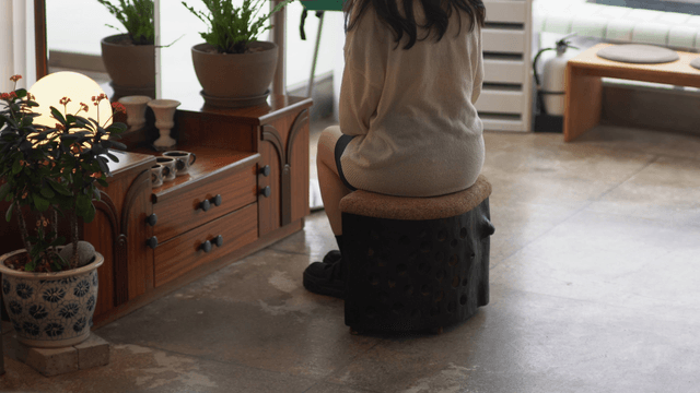 Person sitting in a cozy indoor space