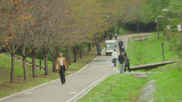 People walking along an autumn park path