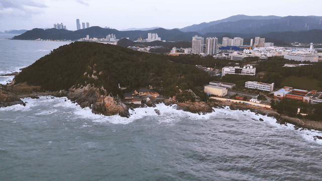Coastal city view with city and a seaside temple
