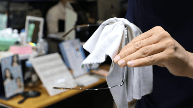Cleaning glasses with a cloth indoors