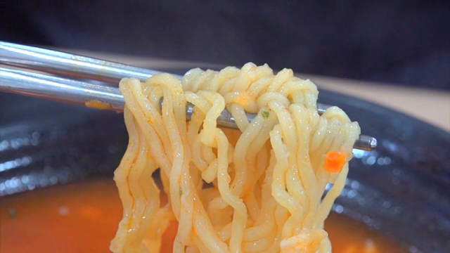 Chopsticks holding ramen noodles