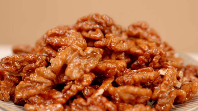 Glazed walnuts piled on a plate