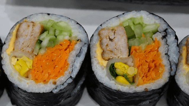 Cross section of gimbap with short rib patties and pickled radish wraps