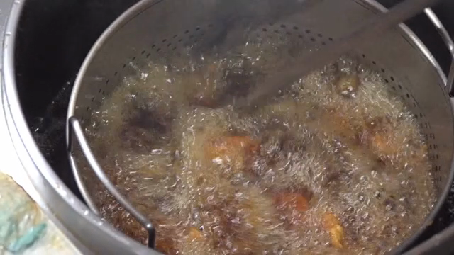 Frying chicken in hot oil