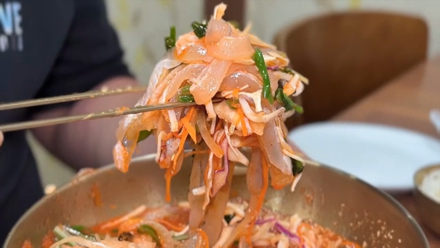 Person enjoying Cold Raw Fish Soup