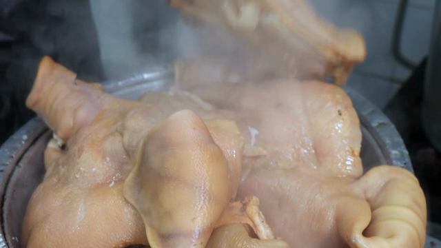 Boiling pork hocks in a steaming pot