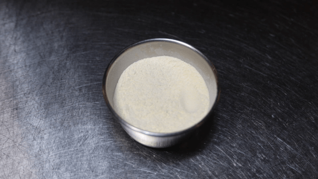 Metal ramekin filled with white flour