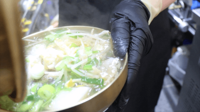 Cod soup poured into brass bowl