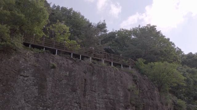 A pavilion on a cliff surrounded by trees