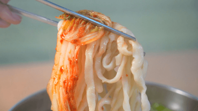 Bowl of kimchi and hand-cut noodles