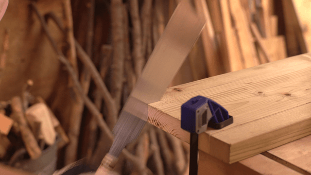 Wood being cut with a handsaw