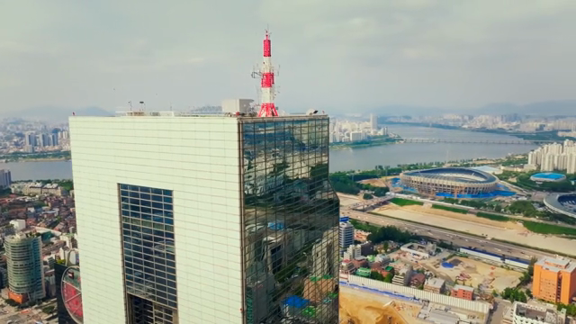 A cityscape with a tall building and river