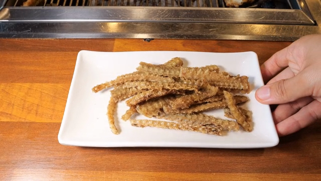 Fried eel bones on a white plate